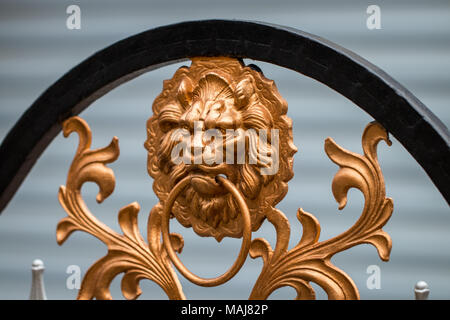 Details, structure and ornaments of forged iron gate. Decorative ornamen with lions , made from metal. Stock Photo