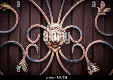 Details, structure and ornaments of forged iron gate. Decorative ornamen with lions , made from metal. Stock Photo