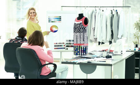 contemporary fashion designer with the creative team Stock Photo
