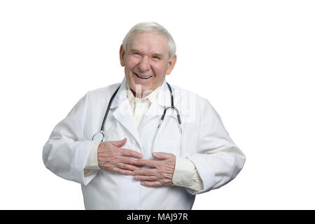 Old doctor laughing heartily touching stomach. Caucasian senior physician having fun in white isolated background. Stock Photo