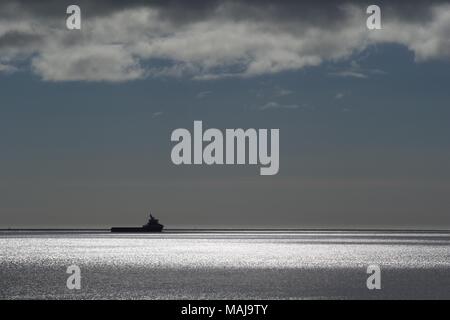 Offshore Support Vessel, Silhouetted on a Sparkling Tranquil North Sea. Aberdeen, Scotland, UK. Stock Photo
