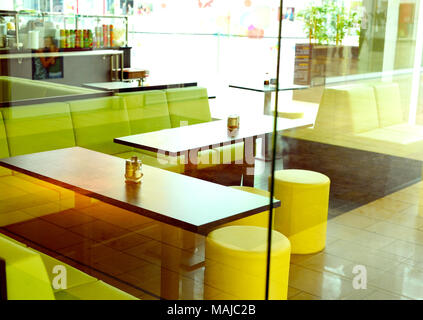 Fast food restaurant, view inside a design restaurant from outside. View trough a window inside of a restaurant, empty seats. Stock Photo