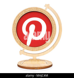 Kiev, Ukraine - November 01, 2017: Pinterest circle icon printed on paper and placed into wooden globe on white background. Pinterest is a web and mob Stock Photo