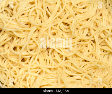 Cooked spaghetti, macro shot. Close-up shot or high angle shot of cooked pasta, italian food or cuisine. Fresh pasta. Stock Photo