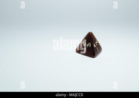 red four-sided dice, isolated on a white background. Dice of role playing game. Stock Photo