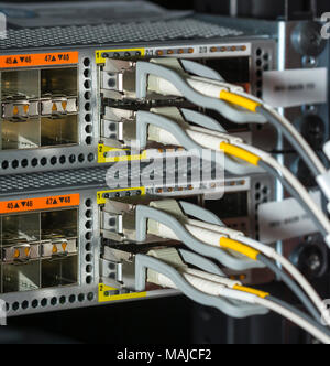 Network cables and servers in a technology data center  Network cables in switch Stock Photo