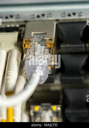 Network cables and servers in a technology data center  Network cables in switch Stock Photo