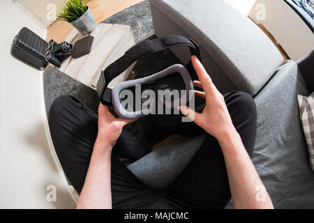 Male hands holding virtual reality headset Stock Photo