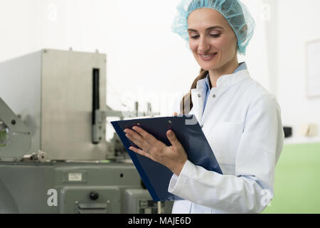 Portrait of woman inspector during quality control in factory Stock Photo