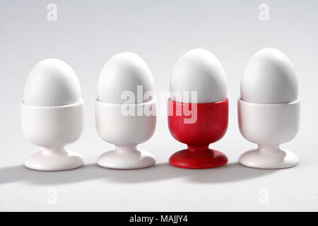 four eggs in cups on white background Stock Photo