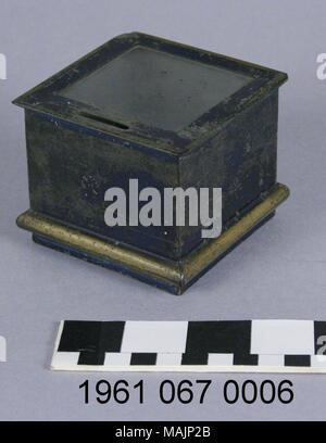 Tin bank in the shape of a blue box with gold trim and glass top. The coin slot is on top. Title: Blue and Gold Box Coin Bank  . circa 1890. Stock Photo