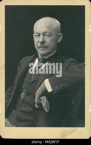 Half-length portrait of Theodore A. Meysenburg wearing a suit, vest, and tie, and seated in a char with his right elbow resting on the back of it. He is holding a glove or handkerchief in his right hand. 'Strauss' (written below image). '1901' (printed in the bottom right corner of image). Title: Theodore A. Meysenburg, Lieutenant Colonel, U.S. Volunteers.  . 1901. Strauss, St. Louis Stock Photo