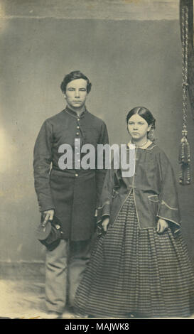 Full-length portrait of unidentified Union soldier in uniform and woman wearing a dress. Soldier has 'E' insignia on top of kepi. Title: Unidentified Union soldier and woman.  . between 1861 and 1865. Leroy Gates, Kilbourn, Wisconsin Stock Photo