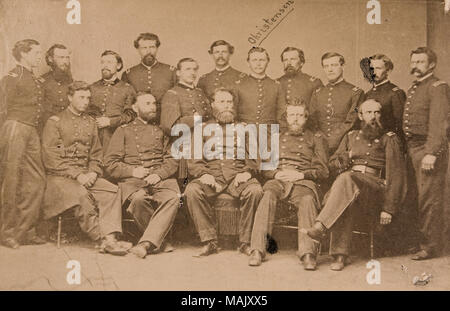 Photograph of Joseph A. Mower (seated in center) surrounded by fifteen staff members in uniform. The man standing to the right of Mower has the hand-written identification 'Christensen' written above his image. Title: 'Major General Joseph A. Mower and Staff' (Union).  . 1865. Stock Photo