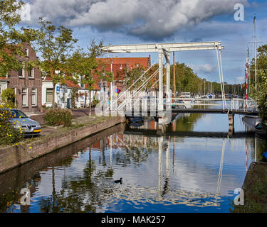 Image of Pedestrian Lifting Bridge over a side canal in Amsterdam, Netherlands, Holland. Stock Photo