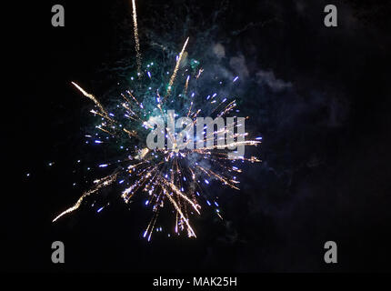 Colorful bright purple fireworks and smoke in the night sky close-up background with a copy space Stock Photo