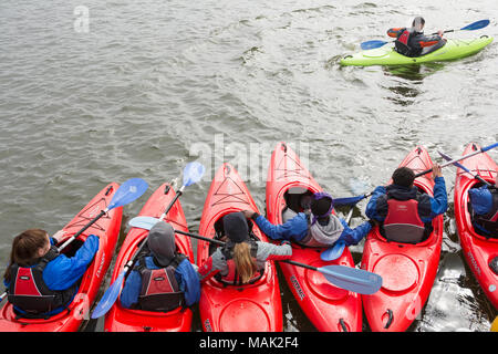 School children enjoying a kayak lesson on the Royal Albert Docks in London Docklands, Newham, London, UK Stock Photo