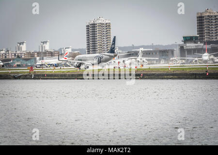 An Alitalia Skyteam Embraer 190 jet landing at London City Airport, an international business airport in the London Borough of Newham, London, UK Stock Photo