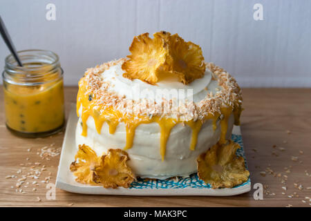 A Gluten Free Pineapple And Coconut Layer Cake With Passion Fruit Curd Decorated With Dried Pineapple Flowers And Displayed On A Handmade Plate Stock Photo Alamy