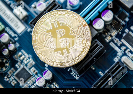 golden coin symbol bitcoin on mother board  Blockchain , cryptocurrencies , bitcoin and distributed ledger technology concept. Stock Photo