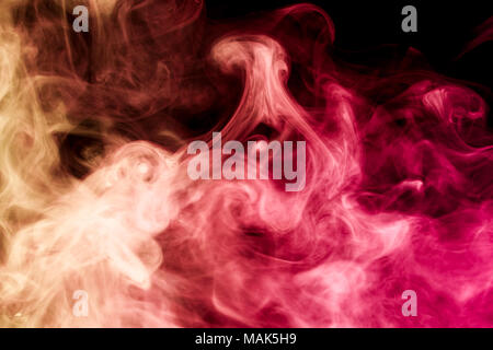 Dense multicolored smoke of   red and pink colors on a black isolated background. Background of smoke vape Stock Photo