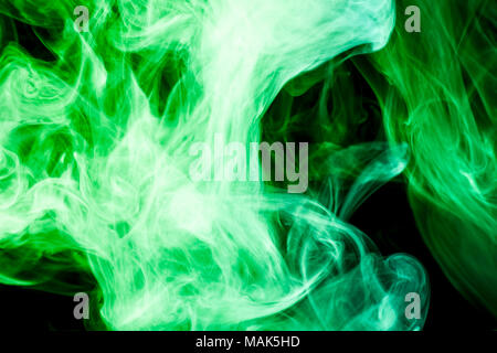Thick colorful smoke of blue, purple on a black isolated background. Background from the smoke of vape Stock Photo