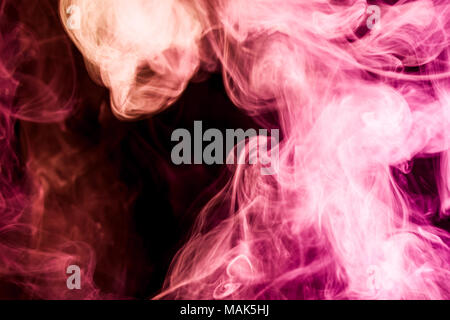 Thick colorful smoke of red, pink on a black isolated background. Background from the smoke of vape Stock Photo