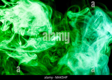 Thick colorful smoke of blue, purple on a black isolated background. Background from the smoke of vape Stock Photo