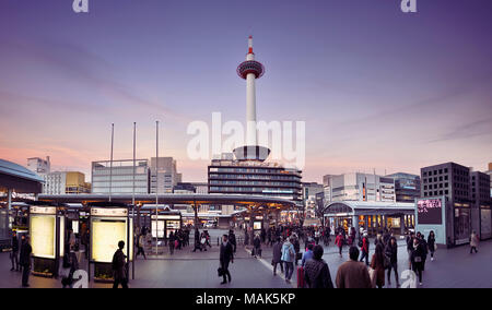 License and prints at MaximImages.com - Kyoto Station busy with people in the evening with Kyoto tower and Kyoto tower hotel beautiful sunset city Stock Photo