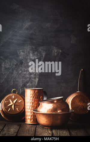 Different kind of vintage copper cookware over dark background Stock Photo