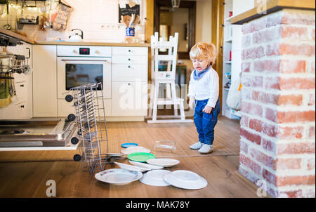 Toddler boy in dangerous situation at home. Child safety concept. Stock Photo