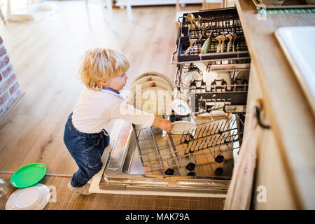 Toddler boy in dangerous situation at home. Child safety concept. Stock Photo