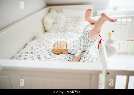 Toddler boy in a dangerous situation at home. Stock Photo