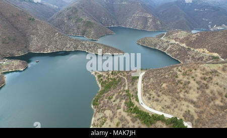 Aerial landscape view of a meandering big river lake and road in the mountain Stock Photo