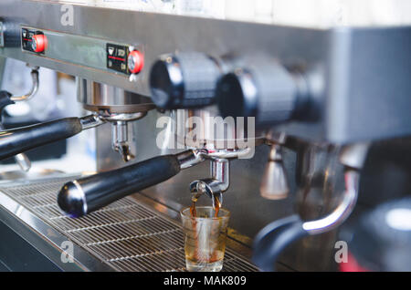 prepares espresso in his coffee shop ; close-up , vintage tone Stock Photo