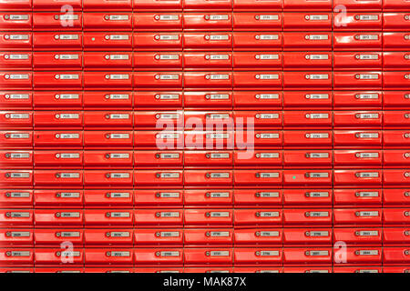 red mailboxes in post office lockable mail boxes wall mounted in a post office new zealand Stock Photo