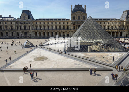 The square courtyard of the Louvre with glass pyramids and the Royal Palace Stock Photo