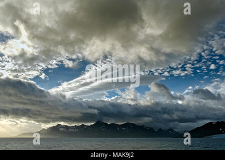 Dramatic sky in early morning light over the mountains of South Georgia Antarctica Stock Photo