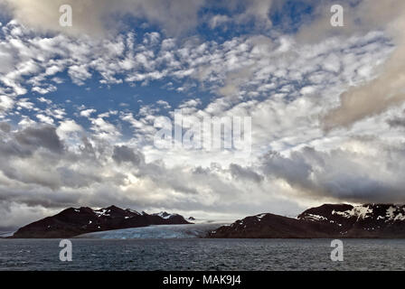 Dramatic sky in early morning light over the mountains of South Georgia Antarctica Stock Photo