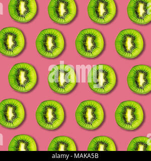 Kiwi fruit slices pattern on vibrant color background. Minimal flat lay food texture