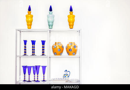 A collection of colourful vases  and drinking blue  glasses on display. - Stock Image. Stock Photo