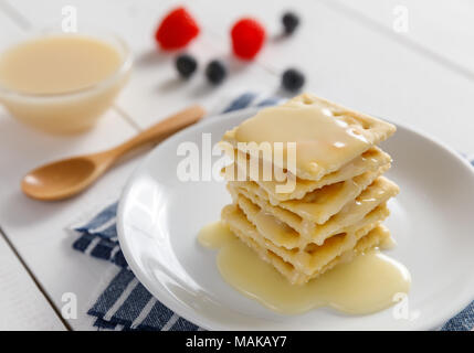 crackers with condensed milk and fruit, breakfast Stock Photo