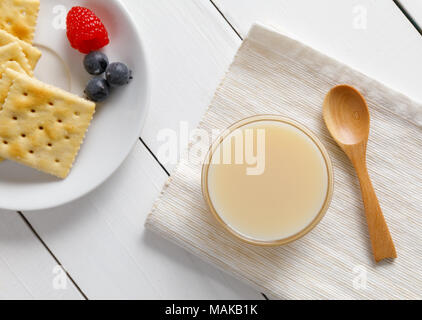 crackers with condensed milk and fruit, breakfast Stock Photo