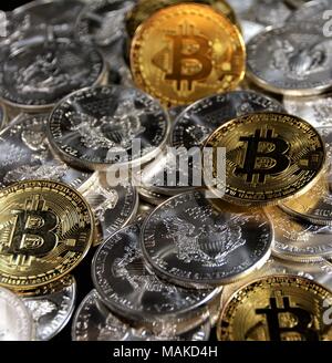 Bit coins with silver dollars and diamonds. Stock Photo