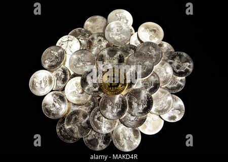 Bit coins with silver dollars and diamonds. Stock Photo