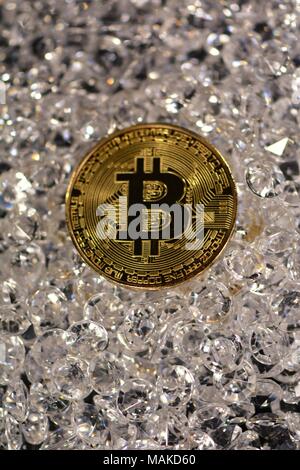 Bit coins with silver dollars and diamonds. Stock Photo