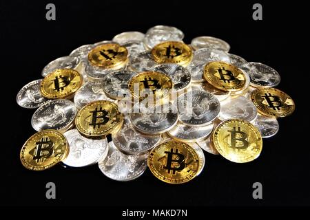 Bit coins with silver dollars and diamonds. Stock Photo