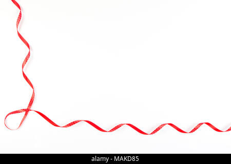 Red and white polka dot ribbon on white background Stock Photo