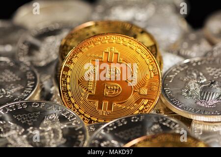 Bit coins with silver dollars and diamonds. Stock Photo