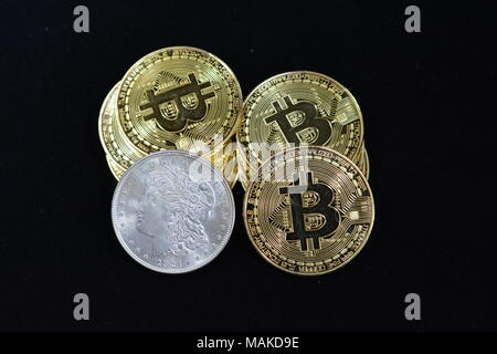 Bit coins with silver dollars and diamonds. Stock Photo